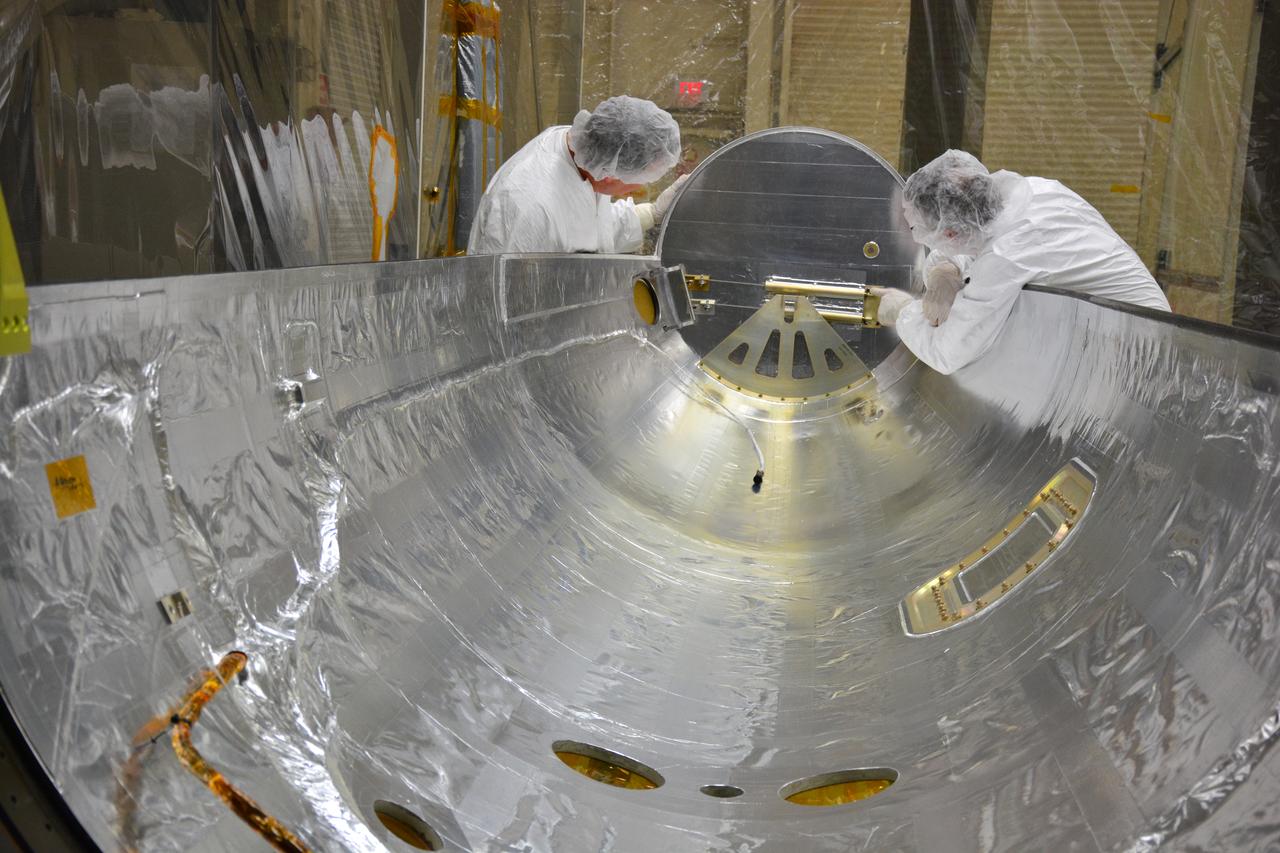 The payload fairing for an Orbital ATK Pegasus XL rocket is inspected in Building 1555 at Vandenberg Air Force Base in California.  The fairing will protect NASA's Cyclone Global Navigation Satellite System (CYGNSS) spacecraft during launch. The rocket and spacecraft are being prepared at Vandenberg, then will be attached to the Orbital ATK L-1011 carrier aircraft and transported to NASA's Kennedy Space Center in Florida. CYGNSS will launch on the Pegasus XL rocket from the Skid Strip at Cape Canaveral Air Force Station. CYGNSS will make frequent and accurate measurements of ocean surface winds throughout the life cycle of tropical storms and hurricanes. The data that CYGNSS provides will enable scientists to probe key air-sea interaction processes that take place near the core of storms, which are rapidly changing and play a critical role in the beginning and intensification of hurricanes.