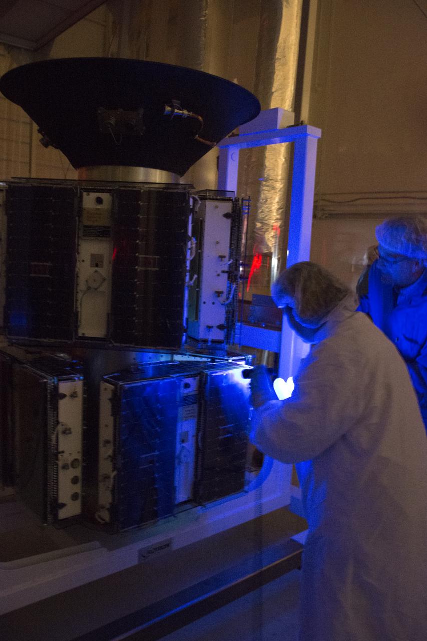 NASA's Cyclone Global Navigation Satellite System (CYGNSS) spacecraft undergoes a black light test in Building 1555 at Vandenberg Air Force Base in California.  CYGNSS is being prepared at Vandenberg, and then will be transported to NASA's Kennedy Space Center in Florida aboard the Orbital ATK Pegasus XL rocket which will be attached to the Orbital ATK L-1011 carrier aircraft. CYGNSS will launch on the Pegasus XL rocket from the Skid Strip at Cape Canaveral Air Force Station. CYGNSS will make frequent and accurate measurements of ocean surface winds throughout the life cycle of tropical storms and hurricanes. The data that CYGNSS provides will enable scientists to probe key air-sea interaction processes that take place near the core of storms, which are rapidly changing and play a critical role in the beginning and intensification of hurricanes.