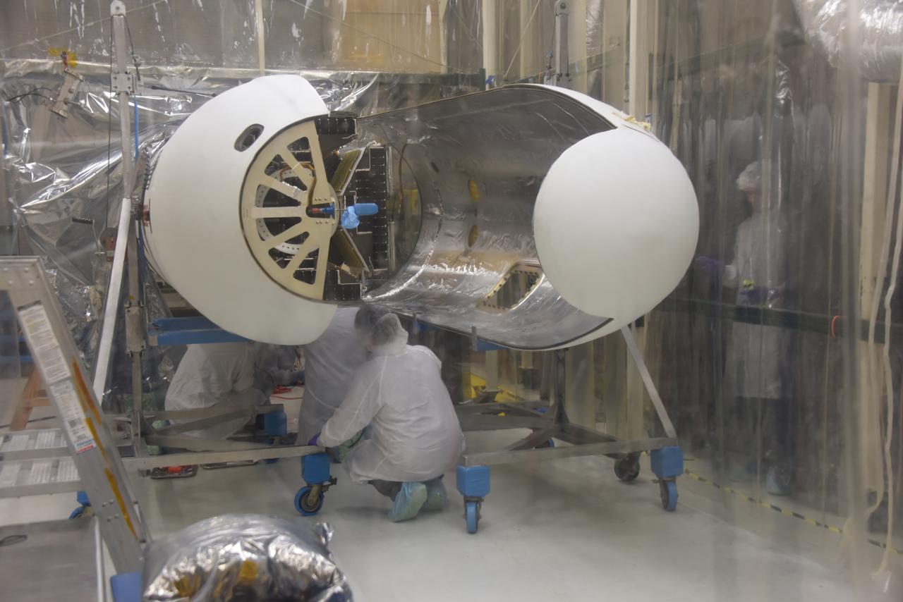 Technicians with Orbital ATK have installed the first half of the Pegasus XL fairing around NASA’s Cyclone Global Navigation Satellite System (CYGNSS) in Building 1555 at Vandenberg Air Force Base in California. Work is underway to install the second half of the fairing. CYGNSS is being prepared at Vandenberg, and then will be transported to NASA’s Kennedy Space Center in Florida aboard the Orbital ATK Pegasus XL rocket which will be attached to the Orbital ATK L-1011 carrier aircraft. CYGNSS will launch on the Pegasus XL rocket from the Skid Strip at Cape Canaveral Air Force Station. CYGNSS will make frequent and accurate measurements of ocean surface winds throughout the life cycle of tropical storms and hurricanes. The data that CYGNSS provides will enable scientists to probe key air-sea interaction processes that take place near the core of storms, which are rapidly changing and play a critical role in the beginning and intensification of hurricanes.