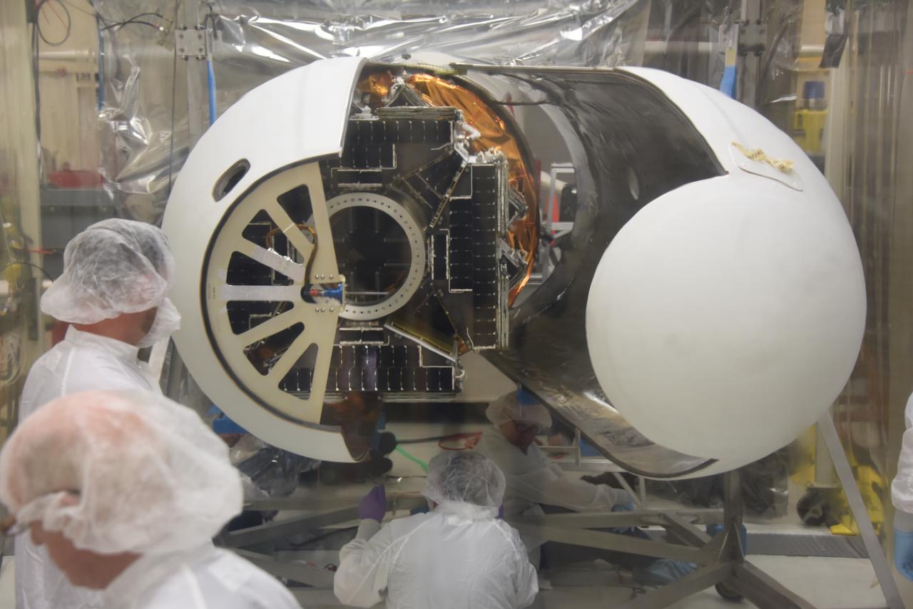 Technicians with Orbital ATK have installed the first half of the Pegasus XL fairing around NASA’s Cyclone Global Navigation Satellite System (CYGNSS) in Building 1555 at Vandenberg Air Force Base in California. The second half of the fairing is being installed. CYGNSS is being prepared at Vandenberg, and then will be transported to NASA’s Kennedy Space Center in Florida aboard the Orbital ATK Pegasus XL rocket which will be attached to the Orbital ATK L-1011 carrier aircraft. CYGNSS will launch on the Pegasus XL rocket from the Skid Strip at Cape Canaveral Air Force Station. CYGNSS will make frequent and accurate measurements of ocean surface winds throughout the life cycle of tropical storms and hurricanes. The data that CYGNSS provides will enable scientists to probe key air-sea interaction processes that take place near the core of storms, which are rapidly changing and play a critical role in the beginning and intensification of hurricanes.