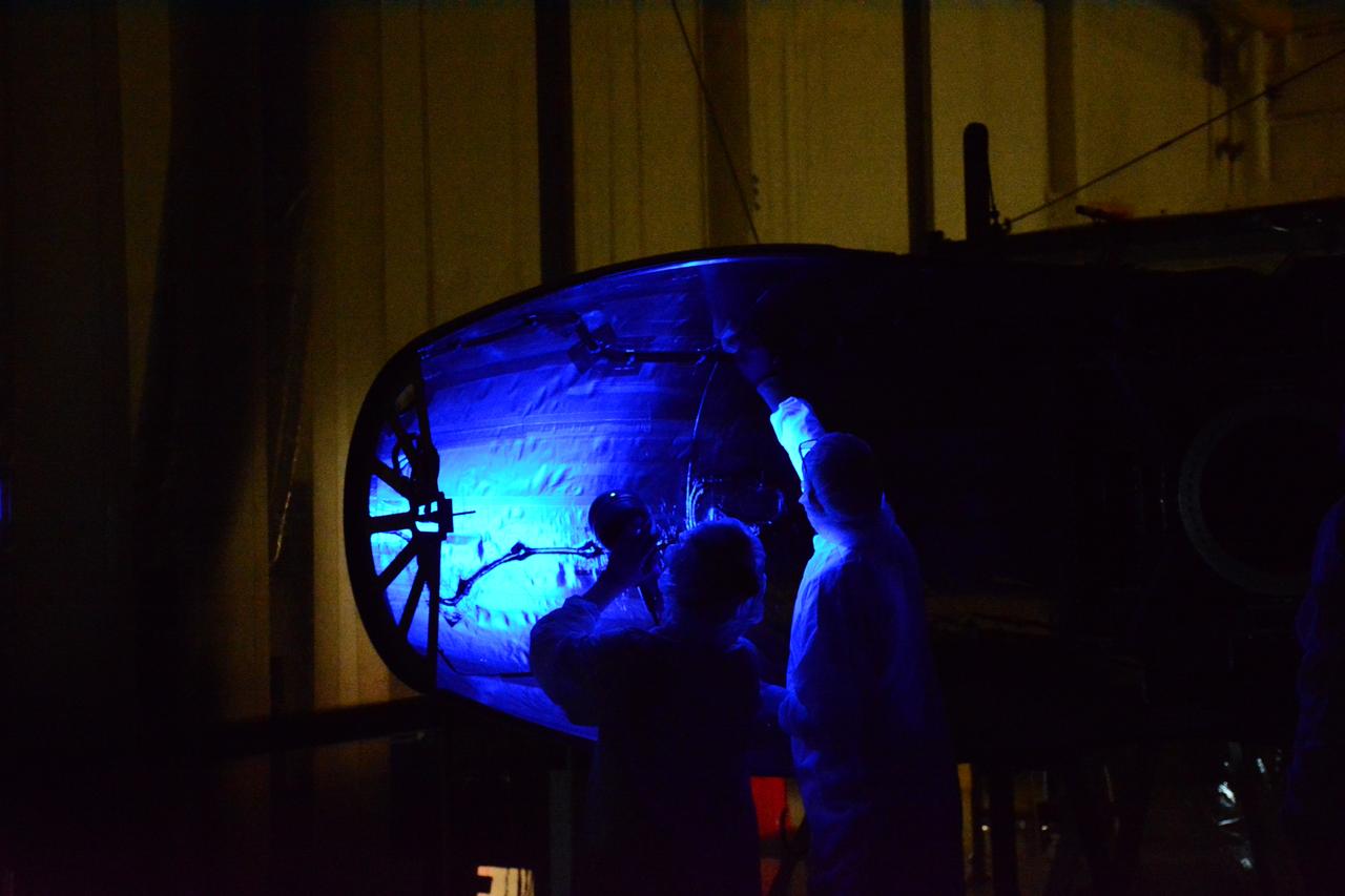Technicians with Orbital ATK perform a black light test on the Pegasus XL fairing inside Building 1555 at Vandenberg Air Force Base in California. NASA’s Cyclone Global Navigation Satellite System (CYGNSS) is being prepared at Vandenberg, and then will be transported to NASA’s Kennedy Space Center in Florida aboard the Orbital ATK Pegasus XL rocket which will be attached to the Orbital ATK L-1011 Stargazer aircraft. CYGNSS will launch on the Pegasus XL rocket from the Skid Strip at Cape Canaveral Air Force Station. CYGNSS will make frequent and accurate measurements of ocean surface winds throughout the life cycle of tropical storms and hurricanes. The data that CYGNSS provides will enable scientists to probe key air-sea interaction processes that take place near the core of storms, which are rapidly changing and play a critical role in the beginning and intensification of hurricanes.