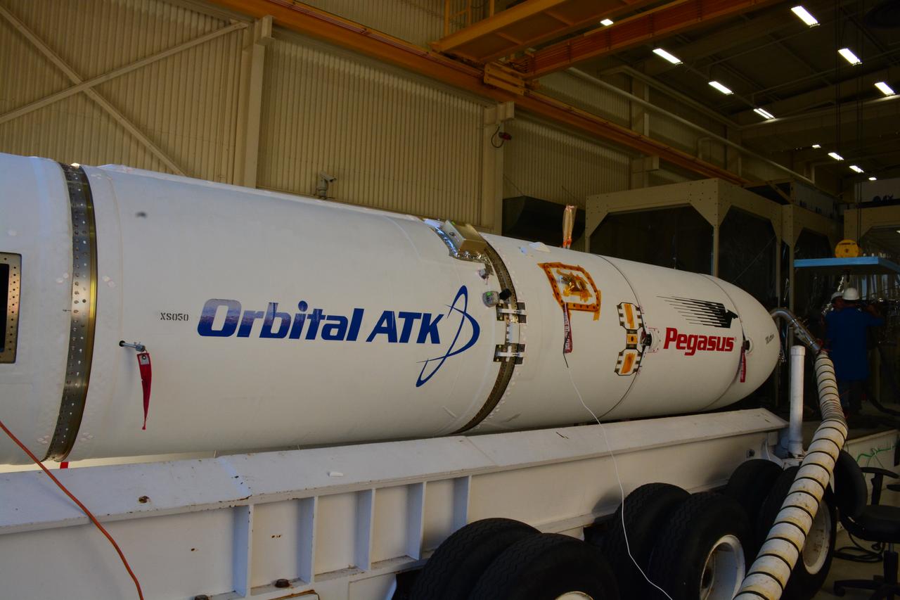 At Vandenberg Air Force Base in California, an Orbital ATK Pegasus XL rocket is placed on an assembly integration transporter for the move from the hangar at Building 1555 to be mated to L-1011 carrier aircraft near Vandenberg's runway. On board Pegasus are eight NASA Cyclone Global Navigation Satellite System, or CYGNSS, spacecraft. When preparations are competed at Vandenberg, the L-1011/Pegasus XL combination will be flown to NASA’s Kennedy Space Center in Florida. On Dec. 12, 2016, the carrier aircraft is scheduled to take off from the Skid Strip at Cape Canaveral Air Force Station and CYGNSS will launch on the Pegasus XL rocket with the L-1011 flying off shore. CYGNSS satellites will make frequent and accurate measurements of ocean surface winds throughout the life cycle of tropical storms and hurricanes. The data that CYGNSS provides will enable scientists to probe key air-sea interaction processes that take place near the core of storms, which are rapidly changing and play a critical role in the beginning and intensification of hurricanes.