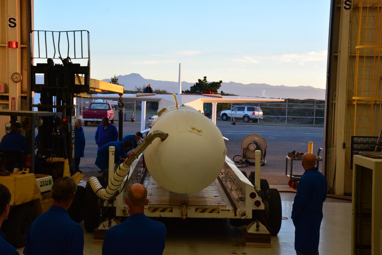 At Vandenberg Air Force Base in California, an Orbital ATK Pegasus XL rocket is placed on an assembly integration transporter for the move from the hangar at Building 1555 to be mated to L-1011 carrier aircraft near Vandenberg's runway. On board Pegasus are eight NASA Cyclone Global Navigation Satellite System, or CYGNSS, spacecraft. When preparations are competed at Vandenberg, the L-1011/Pegasus XL combination will be flown to NASA’s Kennedy Space Center in Florida. On Dec. 12, 2016, the carrier aircraft is scheduled to take off from the Skid Strip at Cape Canaveral Air Force Station and CYGNSS will launch on the Pegasus XL rocket with the L-1011 flying off shore. CYGNSS satellites will make frequent and accurate measurements of ocean surface winds throughout the life cycle of tropical storms and hurricanes. The data that CYGNSS provides will enable scientists to probe key air-sea interaction processes that take place near the core of storms, which are rapidly changing and play a critical role in the beginning and intensification of hurricanes.