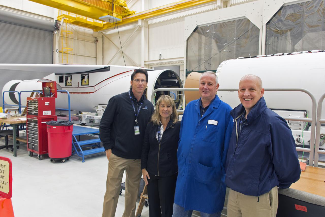 Managers of NASA's Launch Services Program (LSP) at Kennedy Space Center visit the processing facility for the Pegasus XL rocket at Vandenberg Air Force Base in California. From left, are Chuck Dovale, deputy manager; Amanda Mitskevich, manager; Eric Denbrook, launch vehicle processing at VAFB; and Tim Dunn, NASA assistant launch manager for ICON. The Pegasus XL rocket is being prepared for the agency's Ionospheric Connection Explorer, or ICON, mission. ICON will launch from the Kwajalein Atoll aboard the Pegasus XL on Dec. 8, 2017. ICON will study the frontier of space - the dynamic zone high in Earth's atmosphere where terrestrial weather from below meets space weather above. The explorer will help determine the physics of Earth's space environment and pave the way for mitigating its effects on our technology, communications systems and society. 