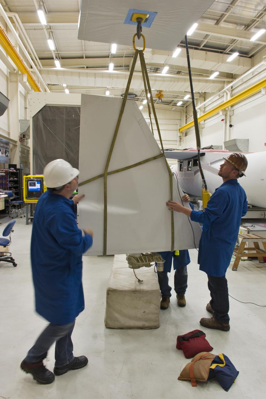 Technicians prepare the rudder for installation on the Orbital ATK Pegasus XL rocket July 8, 2017, inside Building 1555 at Vandenberg Air Force Base in California. The Pegasus rocket is being prepared for NASA's Ionospheric Connection Explorer, or ICON, mission. ICON will launch on June 15 from Kwajalein Atoll in the Marshall Islands (June 14 in the continental United States) on Orbital ATK's Pegasus XL rocket, which is attached to the company's L-1011 Stargazer aircraft. ICON will study the frontier of space - the dynamic zone high in Earth's atmosphere where terrestrial weather from below meets space weather above. The explorer will help determine the physics of Earth's space environment and pave the way for mitigating its effects on our technology, communications systems and society.