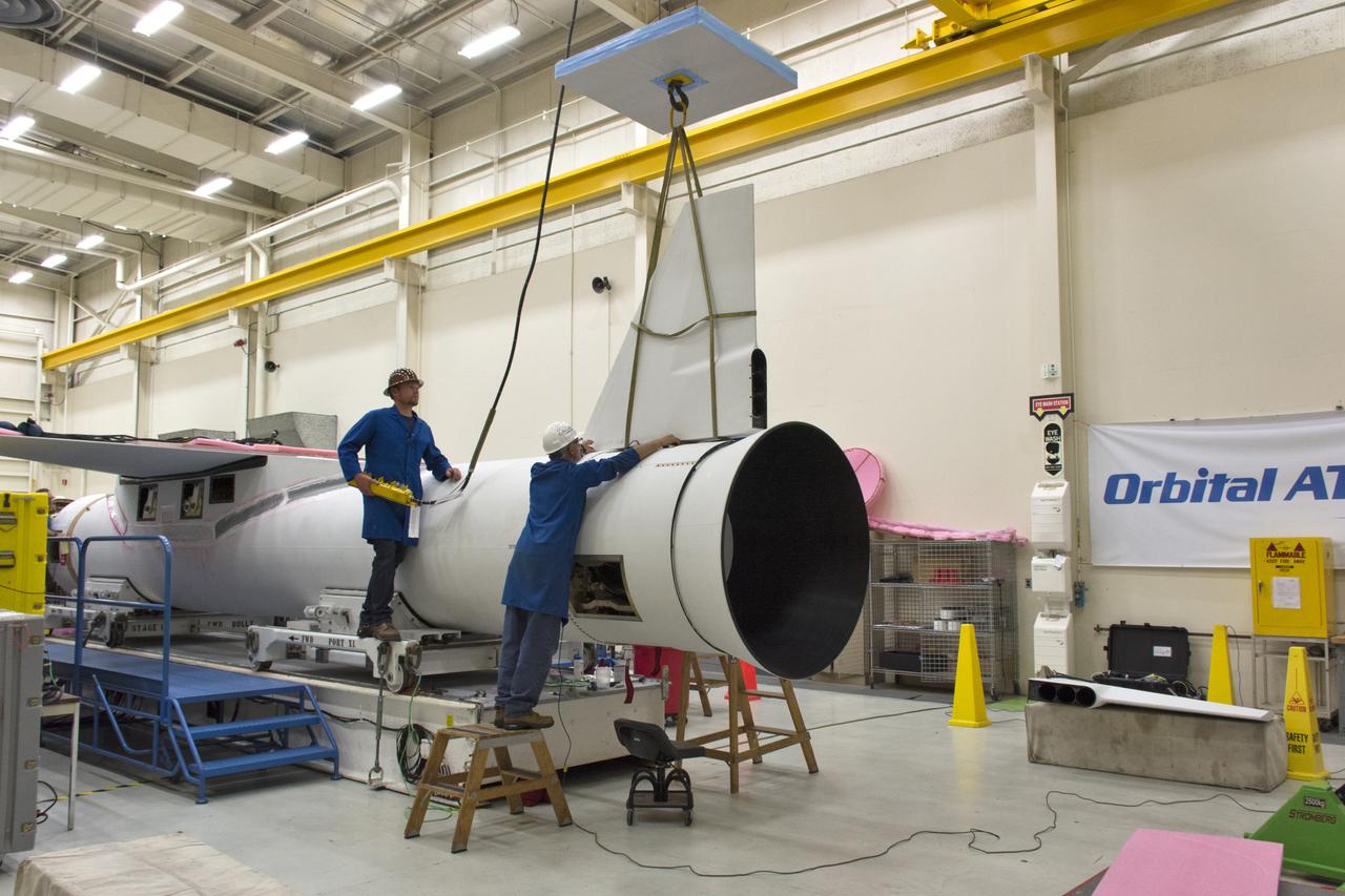 Technicians install the rudder on the Orbital ATK Pegasus XL rocket July 8, 2017, inside Building 1555 at Vandenberg Air Force Base in California. The Pegasus rocket is being prepared for NASA's Ionospheric Connection Explorer, or ICON, mission. ICON will launch on June 15 from Kwajalein Atoll in the Marshall Islands (June 14 in the continental United States) on Orbital ATK's Pegasus XL rocket, which is attached to the company's L-1011 Stargazer aircraft. ICON will study the frontier of space - the dynamic zone high in Earth's atmosphere where terrestrial weather from below meets space weather above. The explorer will help determine the physics of Earth's space environment and pave the way for mitigating its effects on our technology, communications systems and society.