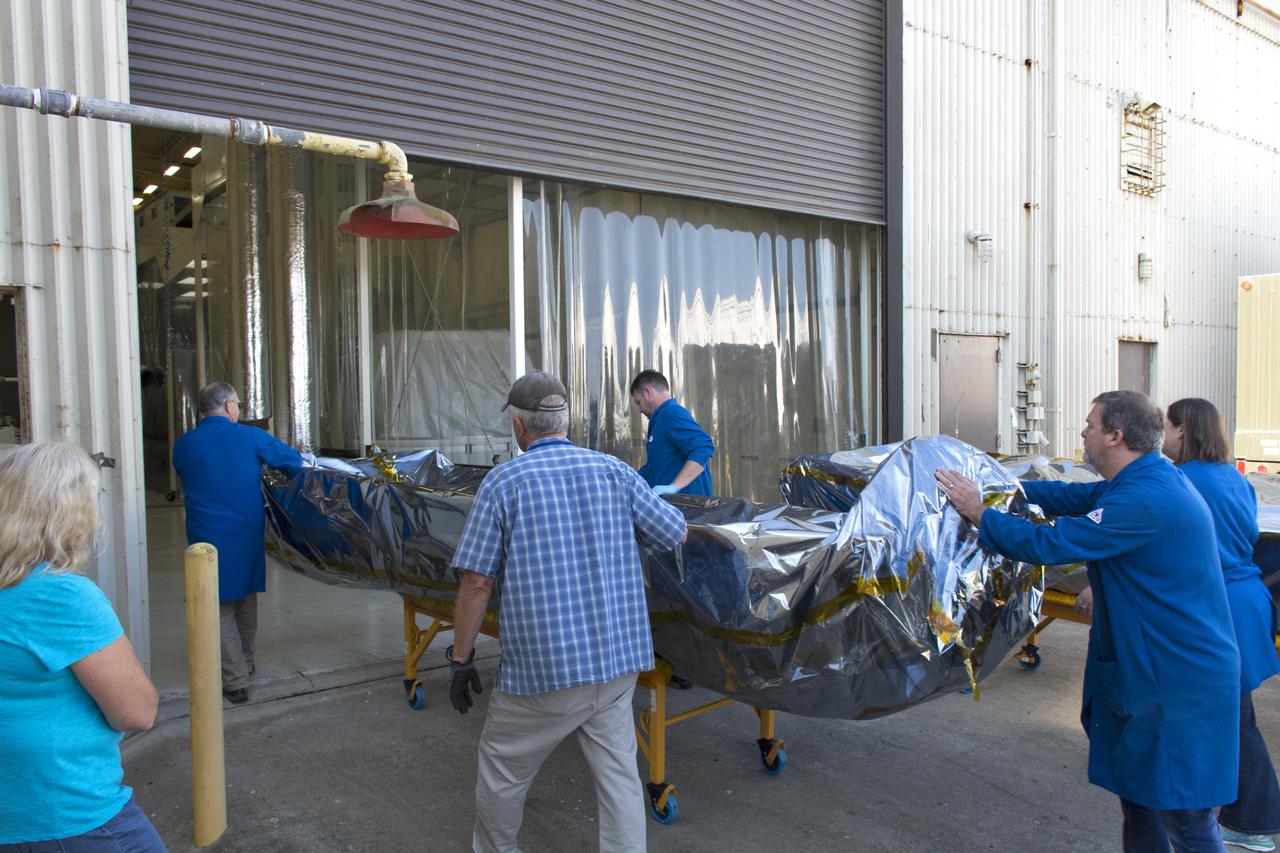 Technicians move the first half of the payload fairing for the Orbital ATK Pegasus XL rocket inside Building 1555 at Vandenberg Air Force Base in California on Aug. 4, 2018. The Pegasus rocket is being prepared for NASA's Ionospheric Connection Explorer, or ICON, mission. The explorer will launch on June 15, 2018, from Kwajalein Atoll in the Marshall Islands (June 14 in the continental United States) on Orbital ATK's Pegasus XL rocket, which is attached to the company's L-1011 Stargazer aircraft. ICON will study the frontier of space - the dynamic zone high in Earth's atmosphere where terrestrial weather from below meets space weather above. The explorer will help determine the physics of Earth's space environment and pave the way for mitigating its effects on our technology, communications systems and society. 