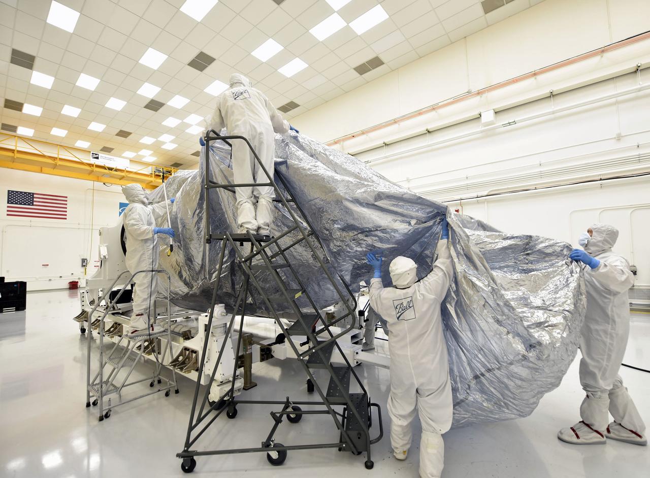 Inside the Astrotech Processing Facility at Vandenberg Air Force Base in California, technicians and engineers remove protective wrapping from the Joint Polar Satellite System-1, or JPSS-1. JPSS is the first in a series four next-generation environmental satellites in a collaborative program between the National Oceanic and Atmospheric Administration (NOAA) and NASA. The satellite is scheduled to liftoff Nov. 10, 2017 atop a United Launch Alliance Delta II rocket.