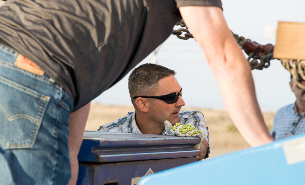 Technicians at Vandenberg Air Force Base in California inspect the shipping container for the Joint Polar Satellite System-1, or JPSS-1, as it arrives at the Astrotech Processing Facility. JPSS is the first in a series four next-generation environmental satellites in a collaborative program between the National Oceanic and Atmospheric Administration (NOAA) and NASA. The satellite is scheduled to liftoff Nov. 10, 2017 atop a United Launch Alliance Delta II rocket.