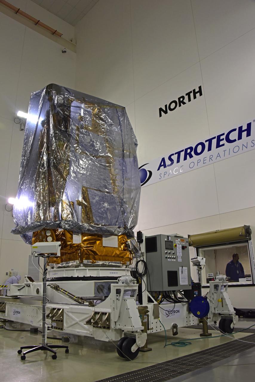 NOAA's Joint Polar Satellite System-1, or JPSS-1, remains wrapped in a protective covering after removal from its shipping container at the Astrotech Processing Facility at Vandenberg Air Force Base in California. The spacecraft is being prepared for its move to a payload attach fitting. JPSS-1 will liftoff aboard a United Launch Alliance Delta II rocket from Vandenberg's Space Launch Complex-2. JPSS-1 is the first in a series of four next-generation environmental satellites in a collaborative program between NOAA and NASA. 