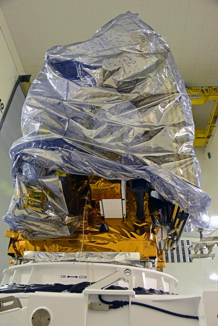 NOAA's Joint Polar Satellite System-1, or JPSS-1, remains wrapped in a protective covering after removal from its shipping container at the Astrotech Processing Facility at Vandenberg Air Force Base in California. The spacecraft is being prepared for its move to a payload attach fitting. JPSS-1 will liftoff aboard a United Launch Alliance Delta II rocket from Vandenberg's Space Launch Complex-2. JPSS-1 is the first in a series of four next-generation environmental satellites in a collaborative program between NOAA and NASA. 