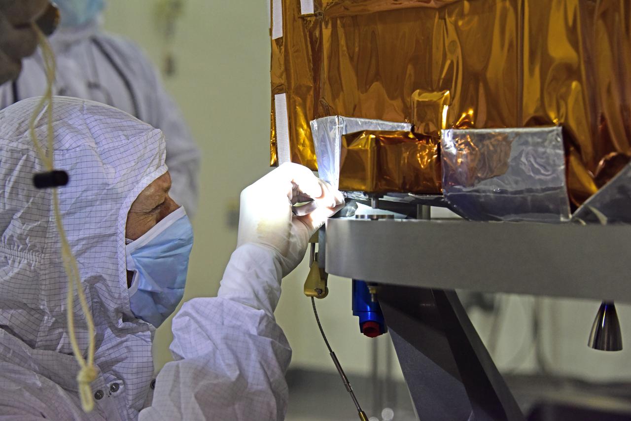 NOAA's Joint Polar Satellite System-1, or JPSS-1, remains wrapped in a protective covering after removal from its shipping container at the Astrotech Processing Facility at Vandenberg Air Force Base in California. Technicians confirm that the spacecraft is secured onto a payload attach fitting. JPSS-1 will liftoff aboard a United Launch Alliance Delta II rocket from Vandenberg's Space Launch Complex-2. JPSS-1 is the first in a series of four next-generation environmental satellites in a collaborative program between NOAA and NASA. 