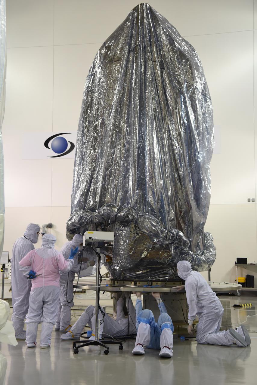 In the Astrotech Processing Facility at Vandenberg Air Force Base in California, the Joint Polar Satellite System-1, or JPSS-1, spacecraft is wrapped in a protective covering prior to being placed it in a protective container. It then will be mounted on a transport trailer for its move to Space Launch Complex 2. At the pad, JPSS-1 will be lifted for mating atop a United Launch Alliance Delta II rocket. Built by Ball Aerospace and Technologies Corp. of Boulder, Colorado, JPSS is the first in a series four next-generation environmental satellites in a collaborative program between the NOAA and NASA. Liftoff is scheduled to take place from Vandenberg's Space Launch Complex 2.