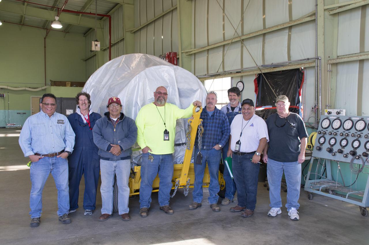 Workers stand with the Delta II second stage inside the horizontal processing facility at Space Launch Complex-2 at Vandenberg Air Force Base in California. NASA's Ice, Cloud and land Elevation Satellite-2 (ICESat-2) will launch later this year on the final Delta II rocket. ICESat-2 will measure the height of a changing Earth, one laser pulse at a time, 10,000 laser pulses a second. The satellite will carry a single instrument, the Advanced Topographic Laser Altimeter System. ICESat-2 will help scientists investigate why, and how much our planet's frozen and icy areas, called the cryosphere, is changing in a warming climate. 