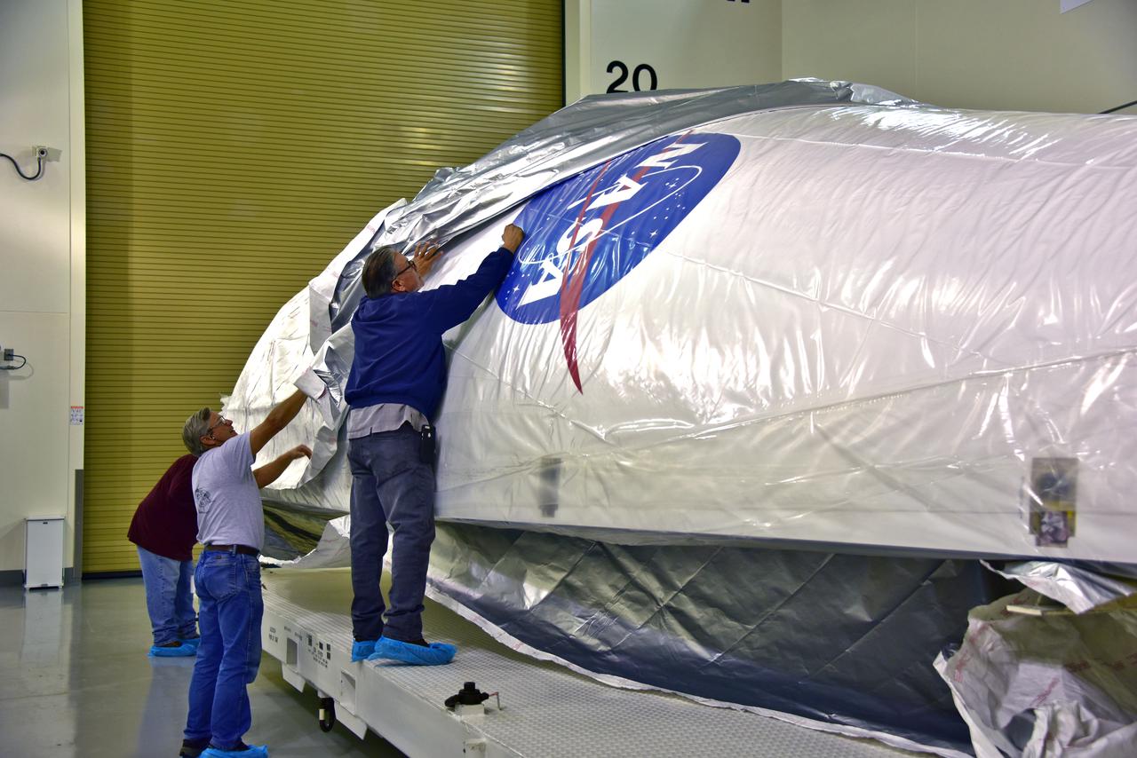 In the Astrotech facility at Vandenberg Air Force Base in California, technicians remove protective wrapping from the United Launch Alliance (ULA) payload fairing for NASA's upcoming Interior Exploration using Seismic Investigations, Geodesy and Heat Transport, or InSight, spacecraft designed to land on Mars. InSight is the first mission to explore the Red Planet's deep interior. It will investigate processes that shaped the rocky planets of the inner solar system including Earth. Liftoff atop a ULA Atlas V rocket is scheduled for May 5, 2018.