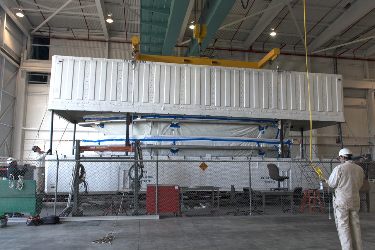 Inside Building 836 at Vandenberg Air Force Base in California, the top of the shipping container is lifted up from the payload fairings for the United Launch Alliance (ULA) Delta II rocket. NASA's Ice, Cloud and land Elevation Satellite-2 (ICESat-2) is scheduled to launch on the final ULA Delta II rocket later this year. ICESat-2 will measure the height of a changing Earth, one laser pulse at a time, 10,000 laser pulses a second. The satellite will carry a single instrument, the Advanced Topographic Laser Altimeter System. ICESat-2 will help scientists investigate why, and how much our planet's frozen and icy areas, called the cryosphere, is changing in a warming climate. 