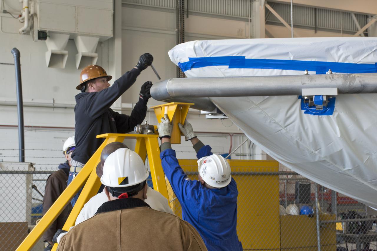 Inside Building 836 at Vandenberg Air Force Base in California, the first half of the payload fairing for the United Launch Alliance (ULA) Delta II rocket has been lifted out of its shipping container. The metal framing around it is being secured on a stand. NASA's Ice, Cloud and land Elevation Satellite-2 (ICESat-2) is scheduled to launch on the final ULA Delta II rocket later this year. ICESat-2 will measure the height of a changing Earth, one laser pulse at a time, 10,000 laser pulses a second. The satellite will carry a single instrument, the Advanced Topographic Laser Altimeter System. ICESat-2 will help scientists investigate why, and how much our planet's frozen and icy areas, called the cryosphere, is changing in a warming climate.