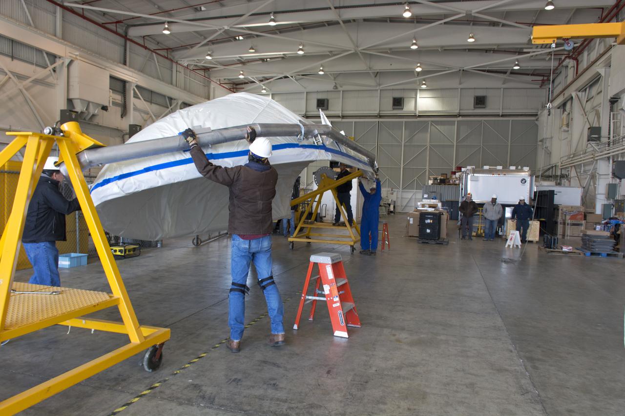 Inside Building 836 at Vandenberg Air Force Base in California, the first half of the payload fairing for the United Launch Alliance (ULA) Delta II rocket has been lifted out of its shipping container. The metal framing around it is being secured on a stand that allows the fairing to be rotated. NASA's Ice, Cloud and land Elevation Satellite-2 (ICESat-2) is scheduled to launch on the final ULA Delta II rocket later this year. ICESat-2 will measure the height of a changing Earth, one laser pulse at a time, 10,000 laser pulses a second. The satellite will carry a single instrument, the Advanced Topographic Laser Altimeter System. ICESat-2 will help scientists investigate why, and how much our planet's frozen and icy areas, called the cryosphere, is changing in a warming climate. 