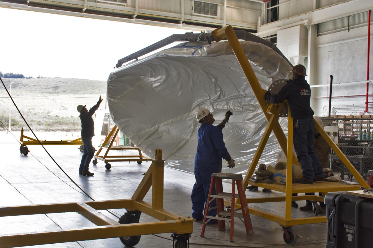 Inside Building 836 at Vandenberg Air Force Base in California, one of the payload fairing halves for the United Launch Alliance (ULA) Delta II rocket is being rotated on its metal frame for securing on a work stand. NASA's Ice, Cloud and land Elevation Satellite-2 (ICESat-2) is scheduled to launch on the final ULA Delta II rocket later this year. ICESat-2 will measure the height of a changing Earth, one laser pulse at a time, 10,000 laser pulses a second. The satellite will carry a single instrument, the Advanced Topographic Laser Altimeter System. ICESat-2 will help scientists investigate why, and how much our planet's frozen and icy areas, called the cryosphere, is changing in a warming climate. 