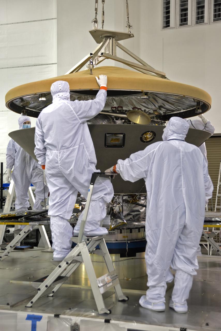 Inside the Astrotech processing facility at Vandenberg Air Force Base in California, technicians and engineers inspect the heatshield for NASA's Interior Exploration using Seismic Investigations, Geodesy and Heat Transport, or InSight, spacecraft. InSight was developed and built by Lockheed-Martin Space Systems in Denver, Colorado, and is scheduled for liftoff is May 5, 2018. InSight is the first mission to land on Mars and explore the Red Planet's deep interior. It will investigate processes that shaped the rocky planets of the inner solar system including Earth.