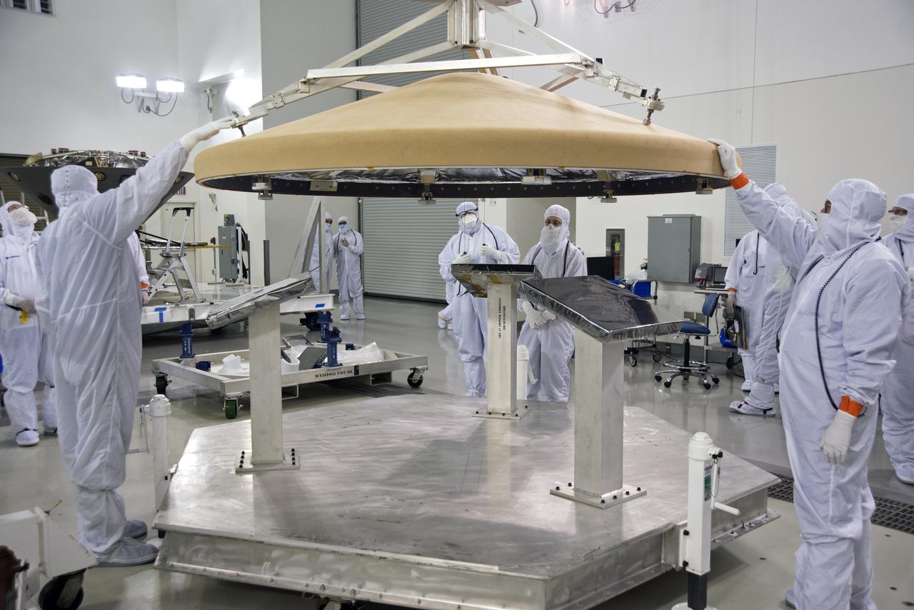 Inside the Astrotech processing facility at Vandenberg Air Force Base in California, technicians and engineers use a crane to move the heatshield for NASA's Interior Exploration using Seismic Investigations, Geodesy and Heat Transport, or InSight, spacecraft for further testing. InSight was developed and built by Lockheed-Martin Space Systems in Denver, Colorado, and is scheduled for liftoff is May 5, 2018. InSight is the first mission to land on Mars and explore the Red Planet's deep interior. It will investigate processes that shaped the rocky planets of the inner solar system including Earth.