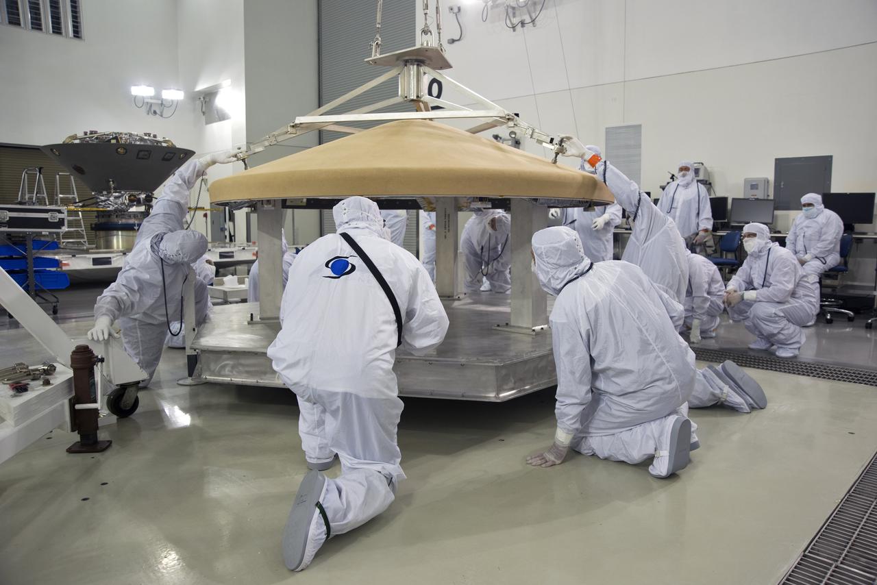 Inside the Astrotech processing facility at Vandenberg Air Force Base in California, technicians and engineers use a crane to move the heatshield for NASA's Interior Exploration using Seismic Investigations, Geodesy and Heat Transport, or InSight, spacecraft for further testing. InSight was developed and built by Lockheed-Martin Space Systems in Denver, Colorado, and is scheduled for liftoff is May 5, 2018. InSight is the first mission to land on Mars and explore the Red Planet's deep interior. It will investigate processes that shaped the rocky planets of the inner solar system including Earth.