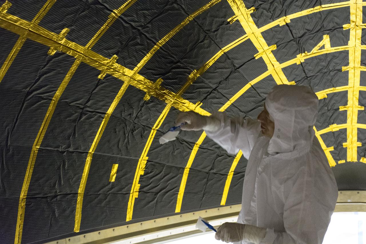 On Friday, April 6, 2018, in NASA’s Building 8337 at Vandenberg Air Force Base in California, a technician cleans and takes samples from the payload fairing the will protect NASA's Ice, Cloud and land Elevation Satellite-2, or ICESat-2, satellite during launch. Liftoff atop a United Launch Alliance Delta II rocket is scheduled for Sept. 12, 2018, from Space Launch Complex-2 at Vandenberg. It will be the last for the venerable Delta II rocket. ICESat-2, which is being built and tested by Orbital ATK in Gilbert, Arizona, will carry a single instrument called the Advanced Topographic Laser Altimeter System, or ATLAS. The ATLAS instrument is being built and tested at NASA’s Goddard Space Flight Center in Greenbelt Maryland. Once in orbit, the satellite is designed to measure the height of a changing Earth, one laser pulse at a time, 10,000 laser pulses a second. ICESat-2 will help scientists investigate why, and how much, Earth’s frozen and icy areas, called the cryosphere, are changing.