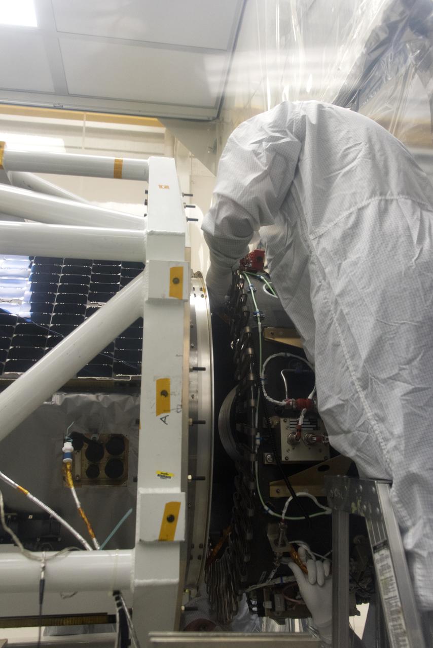 A technician assists as NASA's Ionospheric Connection Explorer (ICON) is being attached to the Orbital ATK Pegasus XL rocket May 14, 2018, inside a clean room in Building 1555 at Vandenberg Air Force Base in California. The explorer will launch on June 15, 2018, from Kwajalein Atoll in the Marshall Islands (June 14 in the continental United States) on the Pegasus XL rocket, which is attached to the company's L-1011 Stargazer aircraft. ICON will study the frontier of space - the dynamic zone high in Earth's atmosphere where terrestrial weather from below meets space weather above. The explorer will help determine the physics of Earth's space environment and pave the way for mitigating its effects on our technology, communications systems and society.
