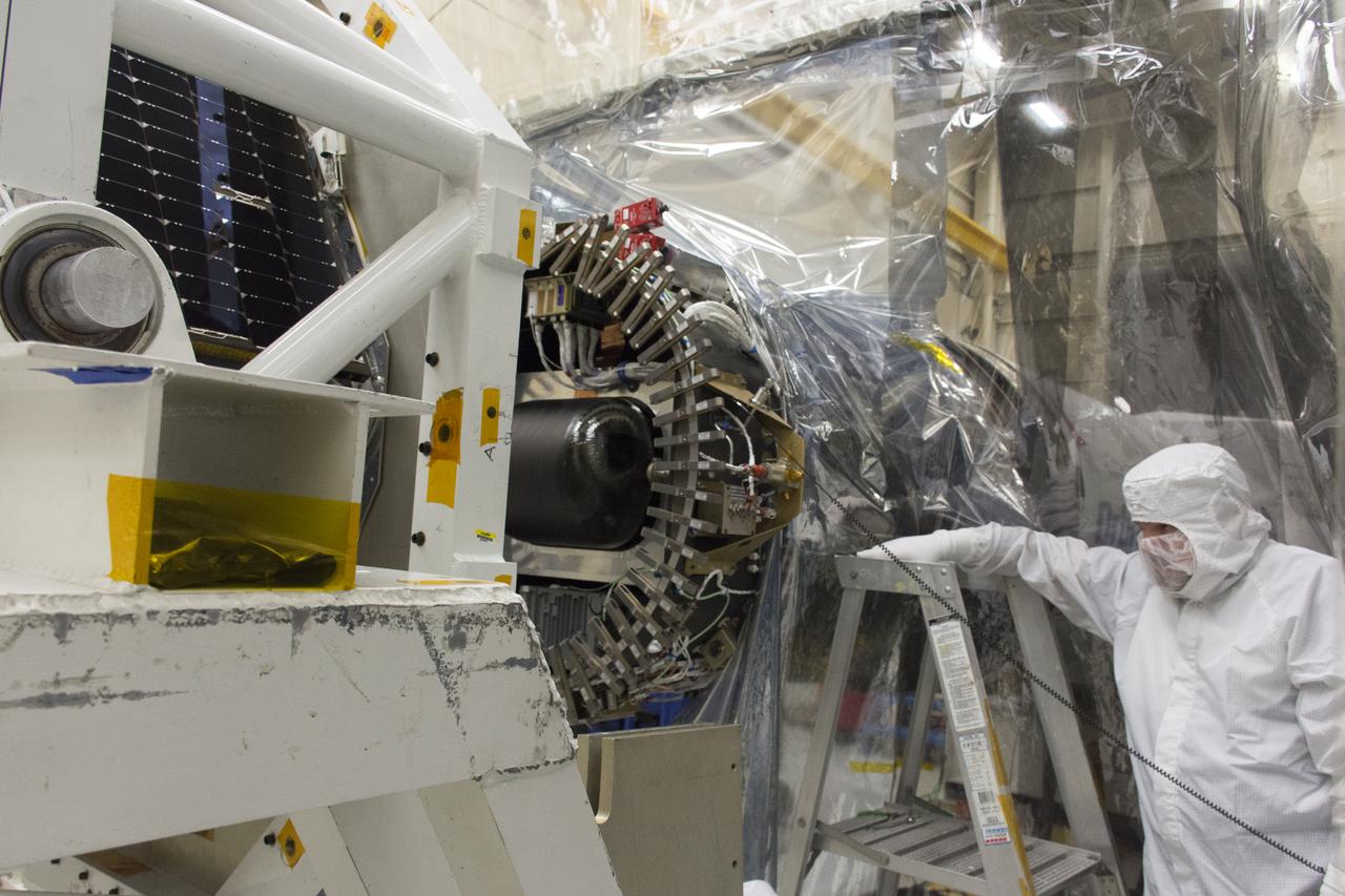 A technician monitors the progress as NASA's Ionospheric Connection Explorer (ICON) is attached to the Orbital ATK Pegasus XL rocket May 14, 2018, inside a clean room in Building 1555 at Vandenberg Air Force Base in California. The explorer will launch on June 15, 2018, from Kwajalein Atoll in the Marshall Islands (June 14 in the continental United States) on the Pegasus XL rocket, which is attached to the company's L-1011 Stargazer aircraft. ICON will study the frontier of space - the dynamic zone high in Earth's atmosphere where terrestrial weather from below meets space weather above. The explorer will help determine the physics of Earth's space environment and pave the way for mitigating its effects on our technology, communications systems and society.