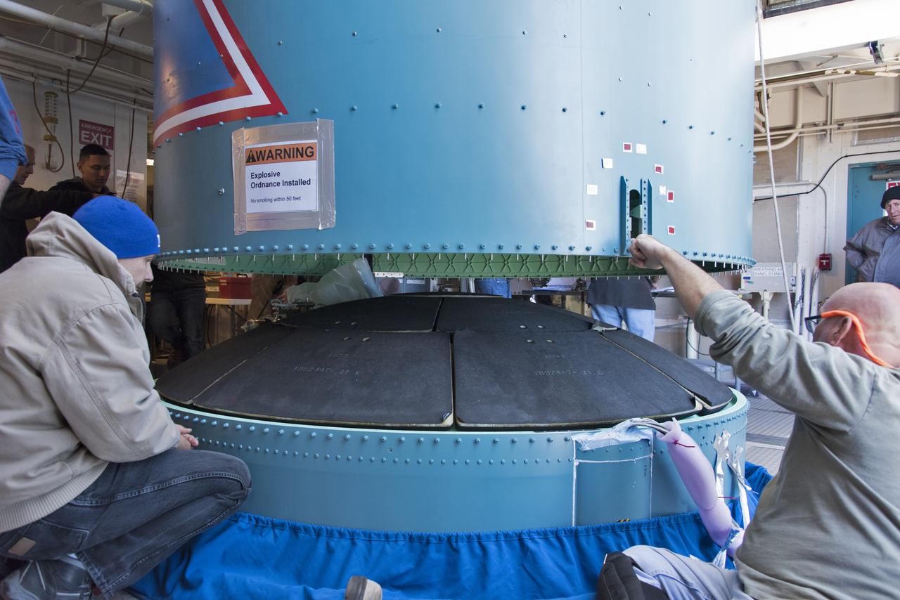 Inside the Vertical Integration Facility at Space Launch Complex 2 at Vandenberg Air Force Base in California, United Launch Alliance (ULA) workers assist as the Delta II interstage is lowered and mated to the booster, or first stage, on June 12, 2018. NASA's Ice, Cloud and land Elevation Satellite-2 (ICESat-2) will launch on the final Delta II rocket. ICESat-2 will measure the height of a changing Earth, one laser pulse at a time, 10,000 laser pulses a second. The satellite will carry a single instrument, the Advanced Topographic Laser Altimeter System. ICESat-2 will help scientists investigate why, and how much our planet's frozen and icy areas, called the cryosphere, is changing in a warming climate.