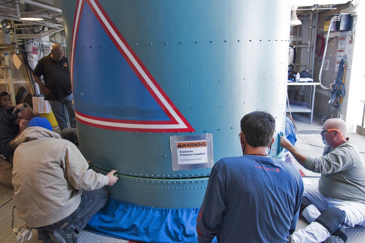 Inside the Vertical Integration Facility at Space Launch Complex 2 at Vandenberg Air Force Base in California, United Launch Alliance (ULA) workers help secure the Delta II interstage to the top of the booster, or first stage, on June 12, 2018. NASA's Ice, Cloud and land Elevation Satellite-2 (ICESat-2) will launch on the final Delta II rocket. ICESat-2 will measure the height of a changing Earth, one laser pulse at a time, 10,000 laser pulses a second. The satellite will carry a single instrument, the Advanced Topographic Laser Altimeter System. ICESat-2 will help scientists investigate why, and how much our planet's frozen and icy areas, called the cryosphere, is changing in a warming climate.