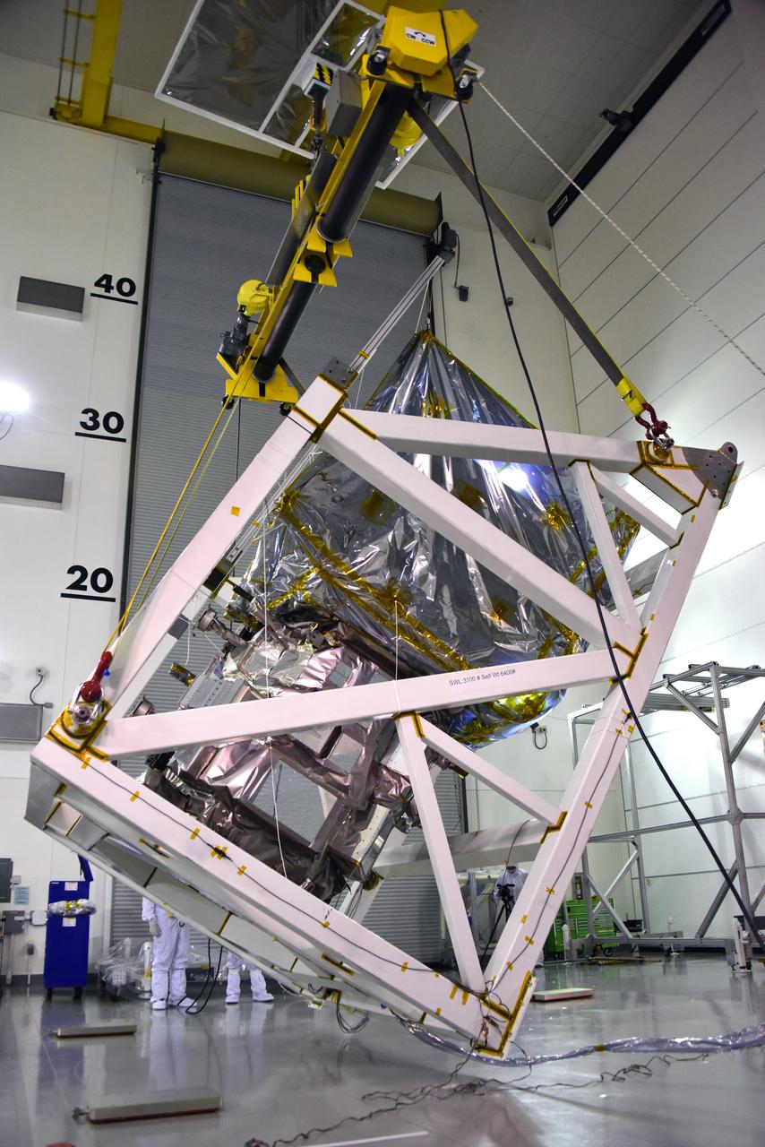 A crane is used to rotate NASA's Ice, Cloud and land Elevation Satellite-2 (ICESat-2) in its fixture inside the high bay of the Astrotech Space Operations facility on June 14, 2018, at Vandenberg Air Force Base in California. ICESat-2 was shipped from the Northrop Grumman facility in Gilbert, Arizona, where it was built and tested. The satellite is scheduled to launch from Space Launch Complex-2 at Vandenberg on the final United Launch Alliance Delta II rocket. ICESat-2 will measure the height of a changing Earth, one laser pulse at a time, 10,000 laser pulses a second. The satellite will carry the Advanced Topographic Laser Altimeter System. ICESat-2 will help scientists investigate why, and how much our planet's frozen and icy areas, called the cryosphere, is changing in a warming climate.