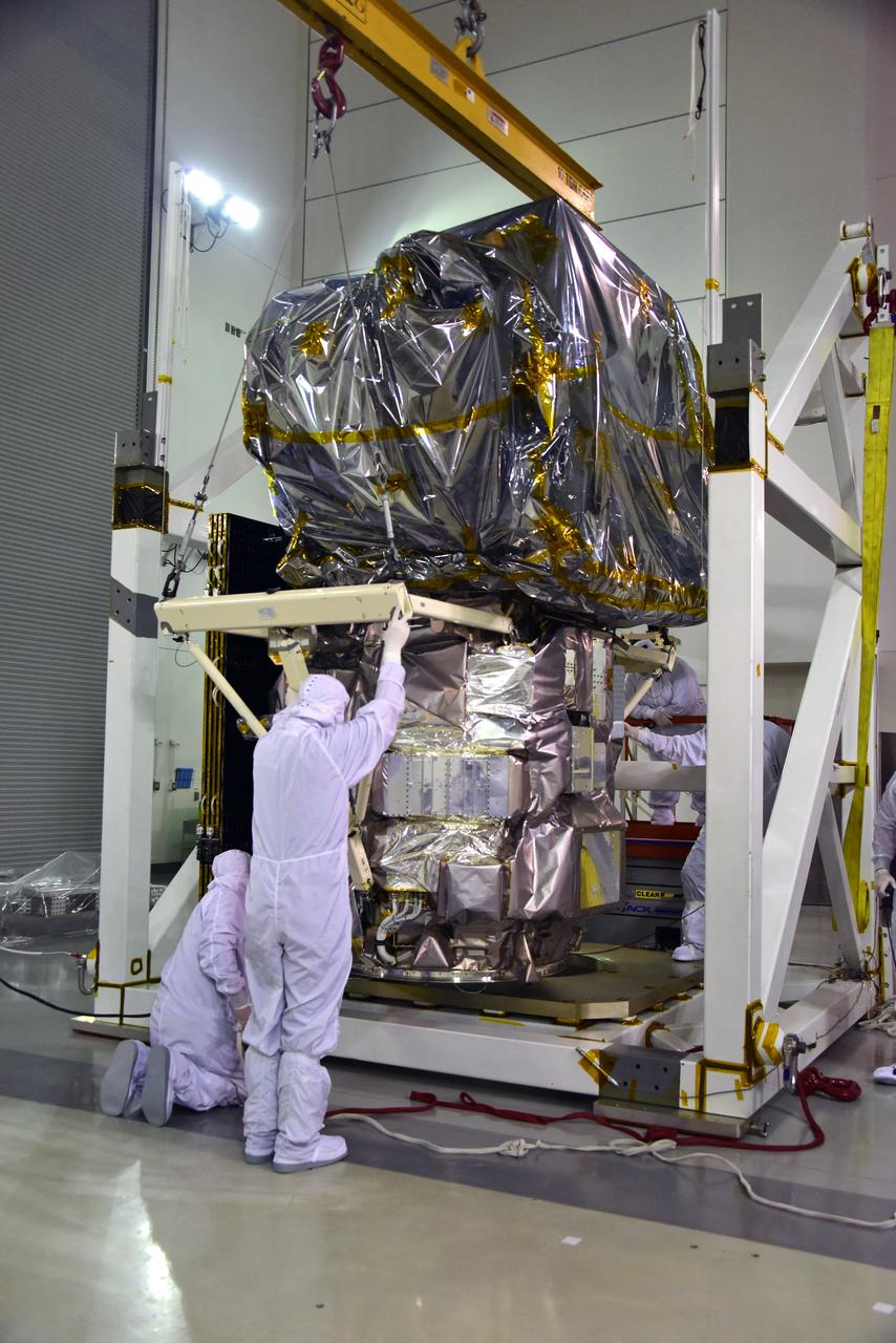 Technicians assist as a crane rotates NASA's Ice, Cloud and land Elevation Satellite-2 (ICESat-2) into position for removal and lift to a work stand in the high bay of the Astrotech Space Operations facility on June 14, 2018, at Vandenberg Air Force Base in California. ICESat-2 was shipped from the Northrop Grumman facility in Gilbert, Arizona, where it was built and tested. The satellite is scheduled to launch from Space Launch Complex-2 at Vandenberg on the final United Launch Alliance Delta II rocket. ICESat-2 will measure the height of a changing Earth, one laser pulse at a time, 10,000 laser pulses a second. The satellite will carry the Advanced Topographic Laser Altimeter System. ICESat-2 will help scientists investigate why, and how much our planet's frozen and icy areas, called the cryosphere, is changing in a warming climate.