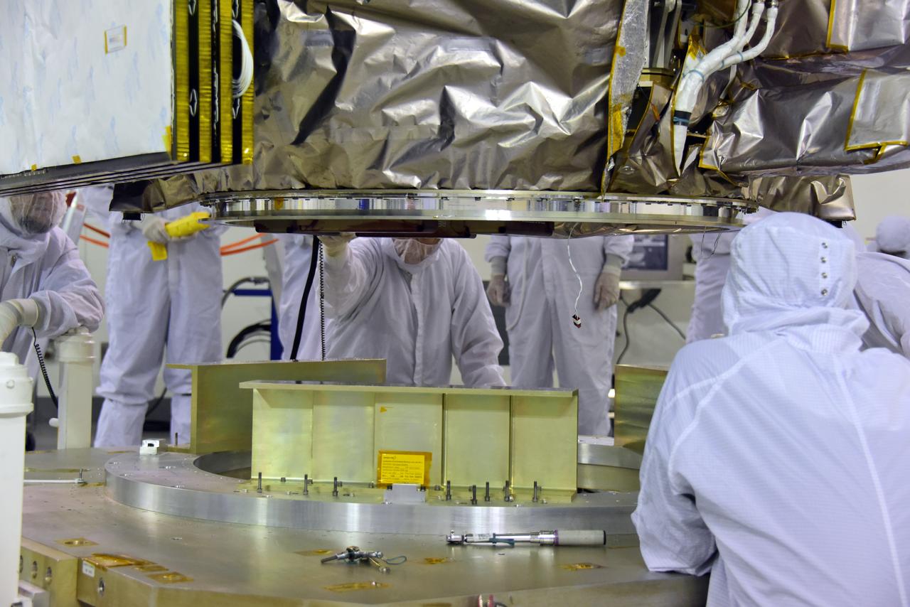 Technicians assist as a crane lowers NASA's Ice, Cloud and land Elevation Satellite-2 (ICESat-2) onto a work stand in the high bay of the Astrotech Space Operations facility on June 14, 2018, at Vandenberg Air Force Base in California. ICESat-2 was shipped from the Northrop Grumman facility in Gilbert, Arizona, where it was built and tested. The satellite is scheduled to launch from Space Launch Complex-2 at Vandenberg on the final United Launch Alliance Delta II rocket. ICESat-2 will measure the height of a changing Earth, one laser pulse at a time, 10,000 laser pulses a second. The satellite will carry the Advanced Topographic Laser Altimeter System. ICESat-2 will help scientists investigate why, and how much our planet's frozen and icy areas, called the cryosphere, is changing in a warming climate.