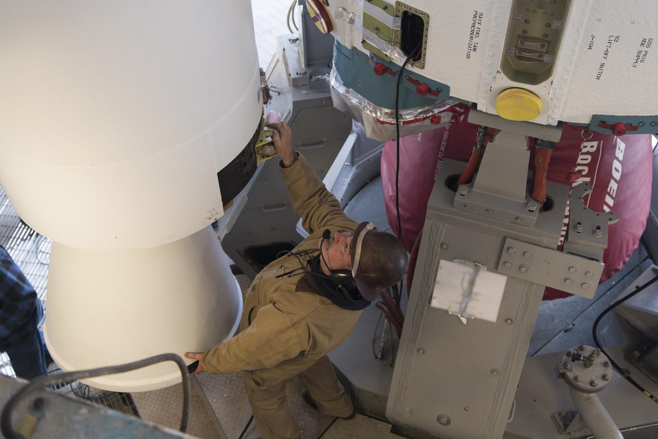 United Launch Alliance (ULA) technicians assist as the solid rocket motor is moved toward the Delta II launch vehicle in the Vertical Integration Facility (VIF) at Space Launch Complex 2 on June 14, 2018, at Vandenberg Air Force Base in California. The solid rocket motor will be attached to the rocket. NASA's Ice, Cloud and land Elevation Satellite-2 (ICESat-2) will launch on the final ULA Delta II rocket. ICESat-2 will measure the height of a changing Earth, one laser pulse at a time, 10,000 laser pulses a second. The satellite will carry a single instrument, the Advanced Topographic Laser Altimeter System. ICESat-2 will help scientists investigate why, and how much our planet's frozen and icy areas, called the cryosphere, is changing in a warming climate.