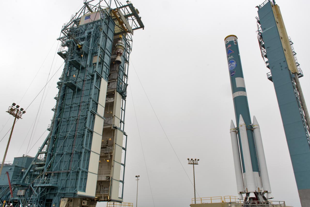 The second stage of the United Launch Alliance Delta II rocket is lifted high up at the Vertical Integration Facility, at left, at Space Launch Complex 2 on June 21, 2018, at Vandenberg Air Force Base in California. The second stage will be attached to the top of the booster, or first stage of the rocket, which is being moved out of the Mobile Service Tower, at right. NASA's Ice, Cloud and land Elevation Satellite-2 (ICESat-2) will launch on the final Delta II rocket. ICESat-2 will measure the height of a changing Earth, one laser pulse at a time, 10,000 laser pulses a second. The satellite will carry a single instrument, the Advanced Topographic Laser Altimeter System. ICESat-2 will help scientists investigate why, and how much our planet's frozen and icy areas, called the cryosphere, is changing in a warming climate.