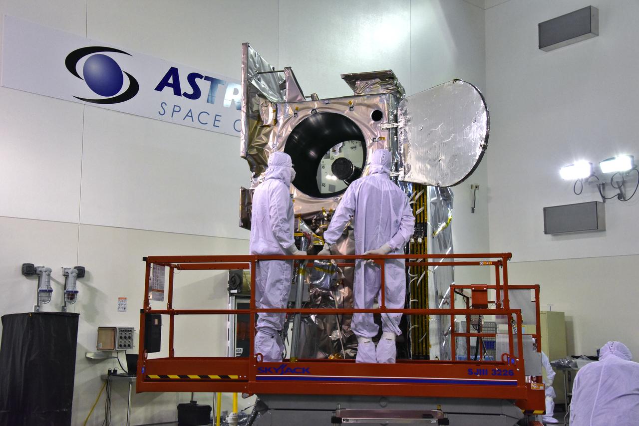 Inside the high bay of the Astrotech Space Operations facility at Vandenberg Air Force Base in California, technicians open and check the flight door for the Advanced Topographic Laser Altimeter System (ATLAS) on NASA's Ice, Cloud and land Elevation Satellite-2 (ICESat-2) on June 18, 2018. The satellite is being prepared for its scheduled launch from Space Launch Complex-2 at Vandenberg on the final United Launch Alliance Delta II rocket. ICESat-2 will measure the height of a changing Earth, one laser pulse at a time, 10,000 laser pulses a second. The satellite will carry ATLAS. ICESat-2 will help scientists investigate why, and how much our planet's frozen and icy areas, called the cryosphere, is changing in a warming climate. 