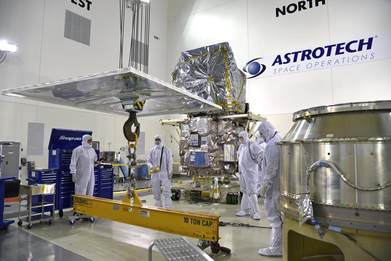Inside the high bay of the Astrotech Space Operations facility at Vandenberg Air Force Base in California, technicians prepare to attach NASA's Ice, Cloud and land Elevation Satellite-2 (ICESat-2) to the payload adapter, on Aug. 20, 2018. The satellite is being prepared for its scheduled launch from Space Launch Complex 2 at Vandenberg on the final United Launch Alliance Delta II rocket. ICESat-2 will measure the height of a changing Earth, one laser pulse at a time, 10,000 laser pulses a second. The satellite will carry the Advanced Topographic Laser Altimeter System (ATLAS). ICESat-2 will help scientists investigate why, and how much our planet's frozen and icy areas, called the cryosphere, are changing in a warming climate.