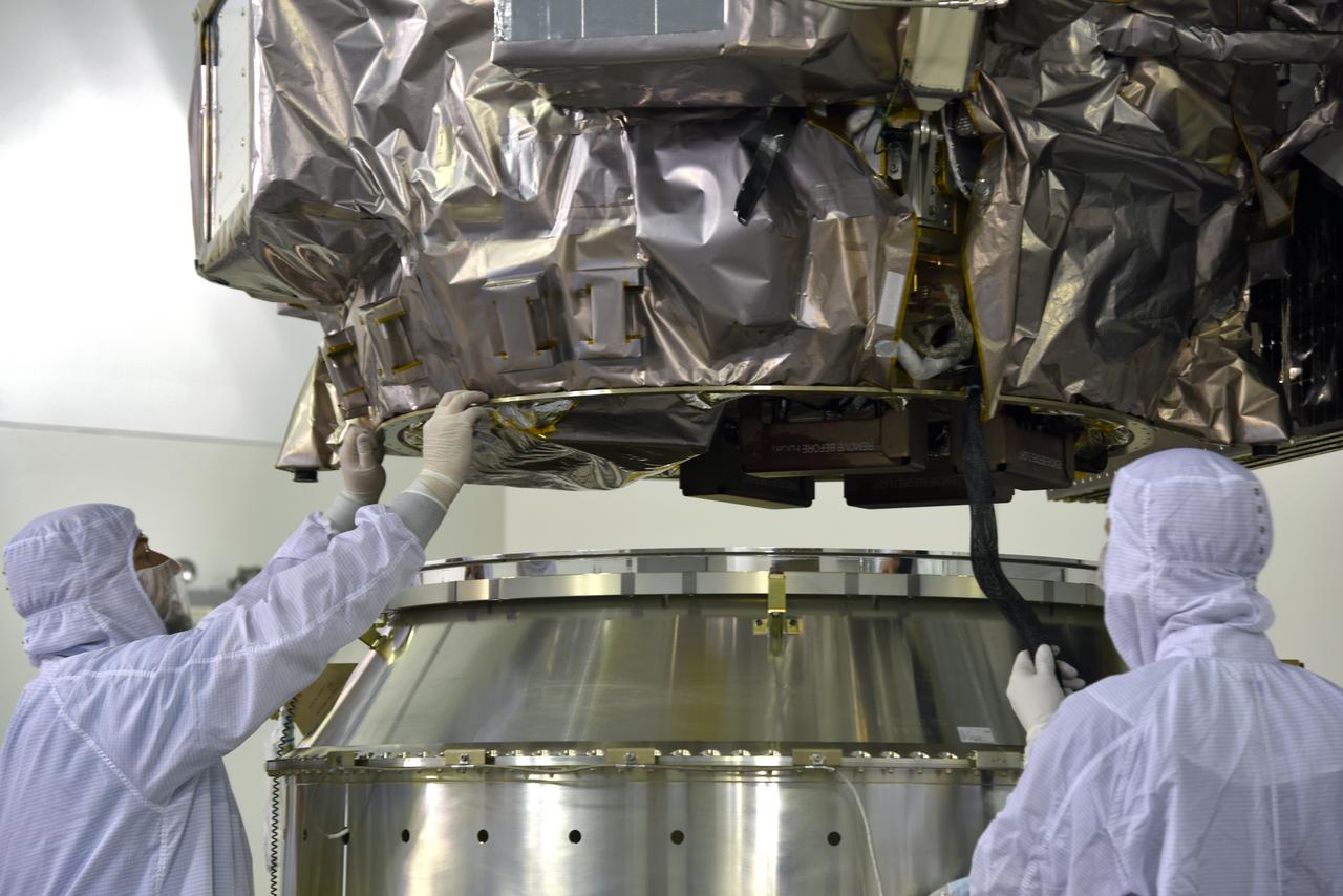 Inside the high bay of the Astrotech Space Operations facility at Vandenberg Air Force Base in California, technicians assist as a crane lowers NASA's Ice, Cloud and land Elevation Satellite-2 (ICESat-2) onto the payload adapter on Aug. 30, 2018. ICESat-2 is being prepared for its scheduled launch from Space Launch Complex 2 at Vandenberg on the final United Launch Alliance Delta II rocket. ICESat-2 will measure the height of a changing Earth, one laser pulse at a time, 10,000 laser pulses a second. The satellite will carry the Advanced Topographic Laser Altimeter System (ATLAS). ICESat-2 will help scientists investigate why, and how much our planet's frozen and icy areas, called the cryosphere, are changing in a warming climate.