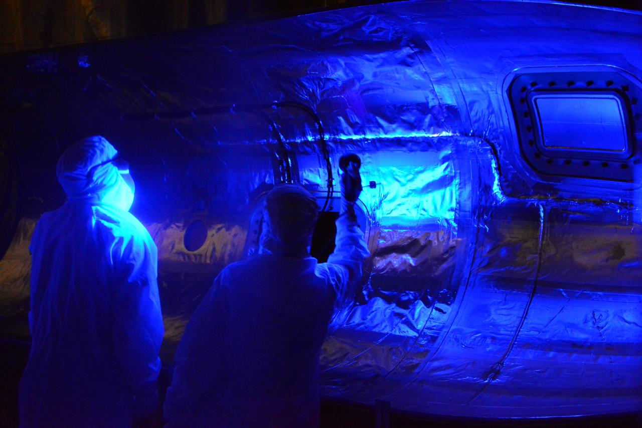 Technicians begin a black light inspection of the Northrop Grumman Pegasus XL rocket inside Building 1555 at Vandenberg Air Force Base in California, on Aug. 22, 2018. The Pegasus port and starboard payload fairings will be installed around NASA's Ionospheric Connection Explorer (ICON). The Pegasus XL rocket, attached beneath the company's L-1011 Stargazer aircraft, will launch ICON from the Skid Strip at Cape Canaveral Air Force Station in Florida. Launch is scheduled for Oct. 26. ICON will study the frontier of space - the dynamic zone high in Earth's atmosphere where terrestrial weather from below meets space weather above. The explorer will help determine the physics of Earth's space environment and pave the way for mitigating its effects on our technology and communications systems.