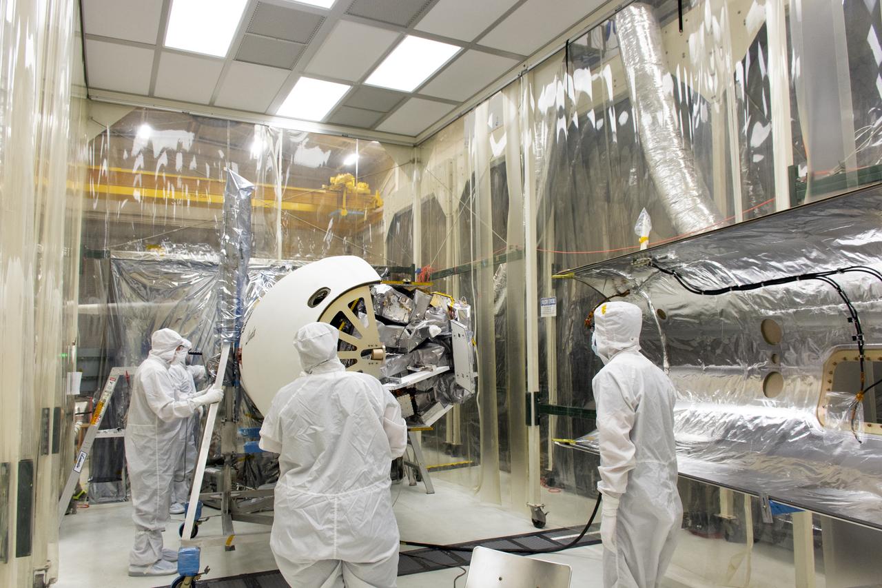 Technicians install the first of two Northrop Grumman Pegasus XL payload fairings around NASA's Ionospheric Connection Explorer (ICON) inside Building 1555 at Vandenberg Air Force Base in California, on Aug. 22, 2018. The Pegasus XL rocket, attached beneath the company's L-1011 Stargazer aircraft, will launch ICON from the Skid Strip at Cape Canaveral Air Force Station in Florida. Launch is scheduled for Oct. 26. ICON will study the frontier of space - the dynamic zone high in Earth's atmosphere where terrestrial weather from below meets space weather above. The explorer will help determine the physics of Earth's space environment and pave the way for mitigating its effects on our technology and communications systems.
