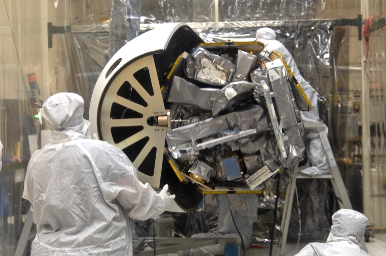 Inside a clean room in Building 1555 at Vandenberg Air Force Base in California, technicians begin to install the first half of the Northrop Grumman Pegasus XL payload fairing around NASA's Ionospheric Connection Explorer (ICON) on Aug. 22, 2018. ICON is being prepared for its launch on the Pegasus XL rocket, which is attached beneath the company's L-1011 Stargazer aircraft. Launch is scheduled for Oct. 26, from the Skid Strip at Cape Canaveral Air Force Station in Florida. ICON will study the frontier of space - the dynamic zone high in Earth's atmosphere where terrestrial weather from below meets space weather above. The explorer will help determine the physics of Earth's space environment and pave the way for mitigating its effects on our technology, communications systems and society.