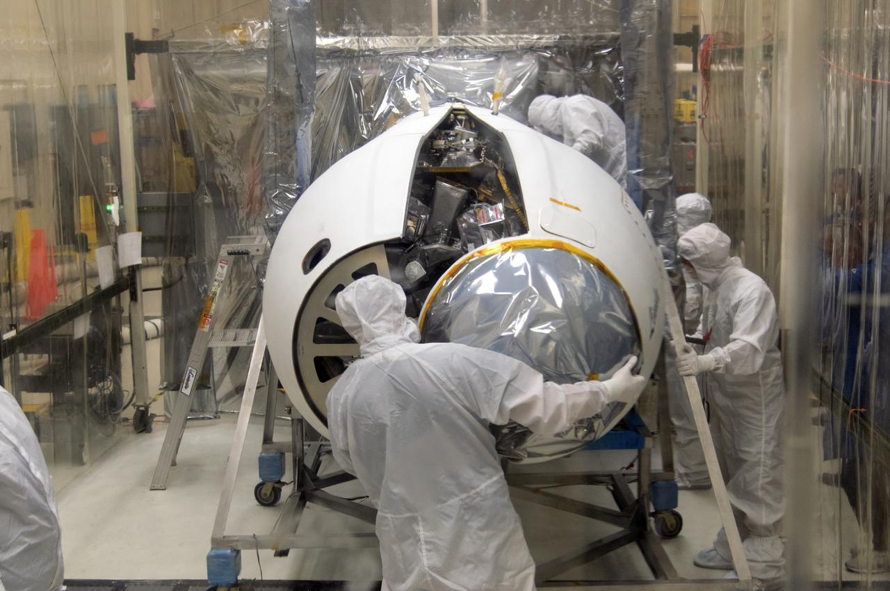 Inside a clean room in Building 1555 at Vandenberg Air Force Base in California, technicians install the second half of the Northrop Grumman Pegasus XL payload fairing around NASA's Ionospheric Connection Explorer (ICON) on Aug. 22, 2018. ICON is being prepared for its launch on the Pegasus XL rocket, which is attached beneath the company's L-1011 Stargazer aircraft. Launch is scheduled for Oct 26, from the Skid Strip at Cape Canaveral Air Force Station in Florida. ICON will study the frontier of space - the dynamic zone high in Earth's atmosphere where terrestrial weather from below meets space weather above. The explorer will help determine the physics of Earth's space environment and pave the way for mitigating its effects on our technology, communications systems and society.