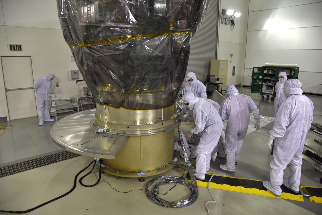 Inside the high bay of the Astrotech Space Operations facility at Vandenberg Air Force Base in California, technicians attach NASA's Ice, Cloud and land Elevation Satellite-2 (ICESat-2) to the payload direct mate adapter, on Aug. 24, 2018. The satellite is being prepared for its scheduled launch from Space Launch Complex 2 at Vandenberg on the final United Launch Alliance Delta II rocket. ICESat-2 will measure the height of a changing Earth, one laser pulse at a time, 10,000 laser pulses a second. The satellite will carry the Advanced Topographic Laser Altimeter System (ATLAS). ICESat-2 will help scientists investigate why, and how much our planet's frozen and icy areas, called the cryosphere, are changing in a warming climate.