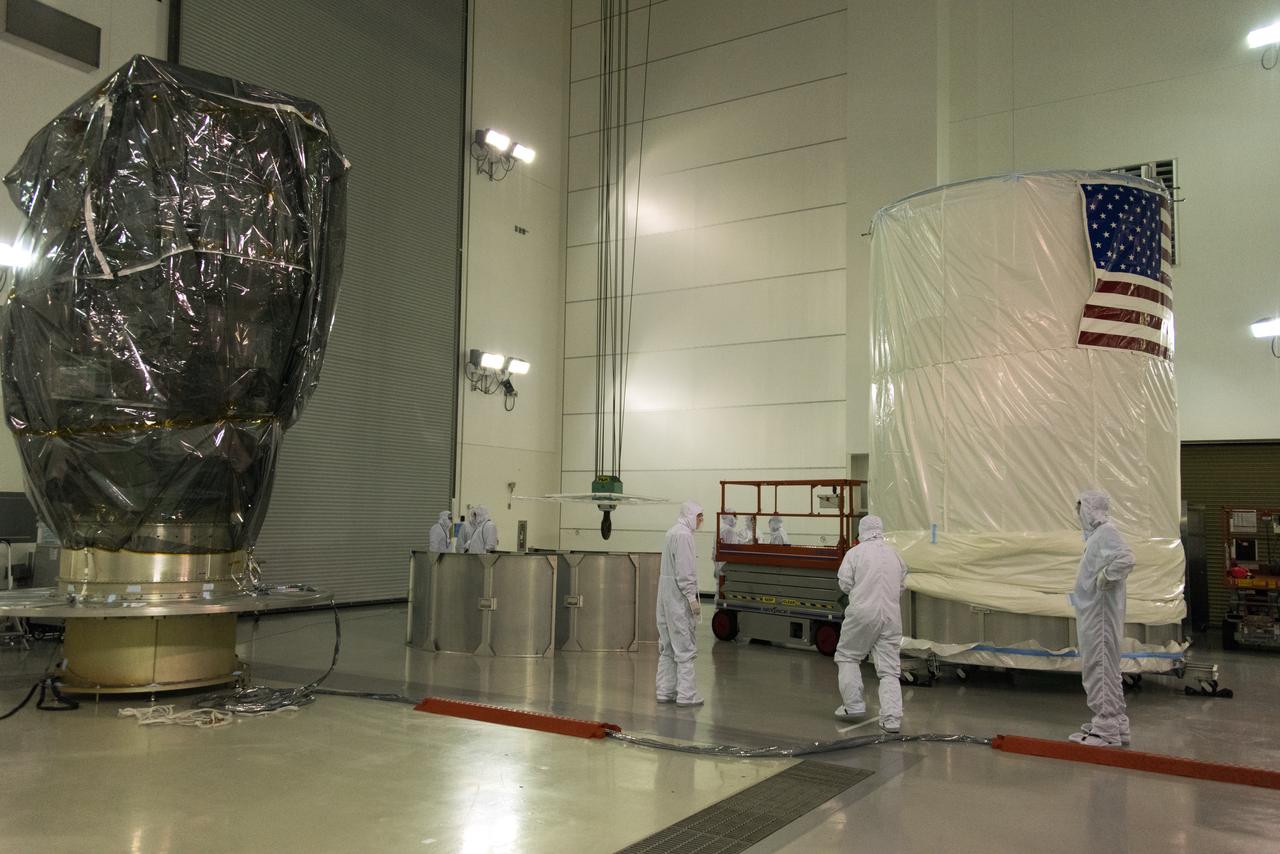 Inside the Astrotech Space Operations high bay at Vandenberg Air Force Base in California, technicians prepare the canister, at right, for installation around NASA's Ice, Cloud and land Elevation Satellite-2 (ICESat-2), at left, on Aug. 25, 2018. The satellite will be transported to Space Launch Complex 2 where it will be hoisted up by crane and attached to the United Launch Alliance Delta II rocket. Launch is scheduled for Sept. 15, 2018. ICESat-2 will measure the height of a changing Earth, one laser pulse at a time, 10,000 laser pulses a second. The satellite will carry the Advanced Topographic Laser Altimeter System (ATLAS). ICESat-2 will help scientists investigate why, and how much our planet's frozen and icy areas, called the cryosphere, are changing in a warming climate.