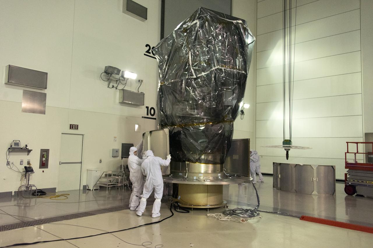 Inside the Astrotech Space Operations high bay at Vandenberg Air Force Base in California, technicians prepare NASA's Ice, Cloud and land Elevation Satellite-2 (ICESat-2), for installation of the protective canister on Aug. 25, 2018. The satellite will be transported to Space Launch Complex 2 where it will be hoisted up by crane and attached to the United Launch Alliance Delta II rocket. Launch is scheduled for Sept. 15, 2018. ICESat-2 will measure the height of a changing Earth, one laser pulse at a time, 10,000 laser pulses a second. The satellite will carry the Advanced Topographic Laser Altimeter System (ATLAS). ICESat-2 will help scientists investigate why, and how much our planet's frozen and icy areas, called the cryosphere, are changing in a warming climate.