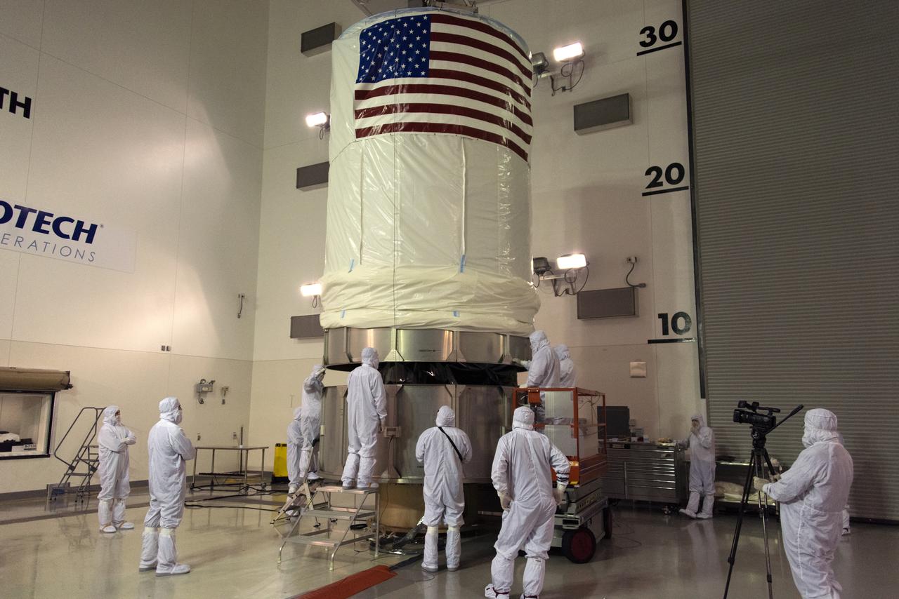 Inside the Astrotech Space Operations high bay at Vandenberg Air Force Base in California, the protective canister is lowered down over NASA's Ice, Cloud and land Elevation Satellite-2 (ICESat-2), on Aug. 25, 2018. The satellite will be transported to Space Launch Complex 2 where it will be hoisted up by crane and attached to the United Launch Alliance Delta II rocket. Launch is scheduled for Sept. 15, 2018. ICESat-2 will measure the height of a changing Earth, one laser pulse at a time, 10,000 laser pulses a second. The satellite will carry the Advanced Topographic Laser Altimeter System (ATLAS). ICESat-2 will help scientists investigate why, and how much our planet's frozen and icy areas, called the cryosphere, are changing in a warming climate.