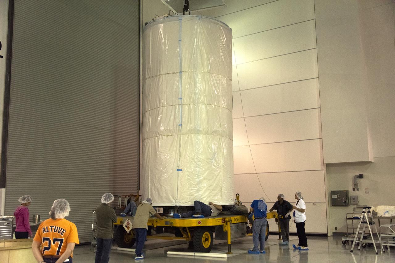 Technicians assist as NASA's Ice, Cloud and land Elevation Satellite-2 (ICESat-2), inside its protective canister, is lowered onto a transport trailer inside the Astrotech Space Operations high bay at Vandenberg Air Force Base in California, on Aug. 25, 2018. The satellite will be transported to Space Launch Complex 2 where it will be hoisted up by crane and attached to the United Launch Alliance Delta II rocket. Launch is scheduled for Sept. 15, 2018. ICESat-2 will measure the height of a changing Earth, one laser pulse at a time, 10,000 laser pulses a second. The satellite will carry the Advanced Topographic Laser Altimeter System (ATLAS). ICESat-2 will help scientists investigate why, and how much our planet's frozen and icy areas, called the cryosphere, are changing in a warming climate.