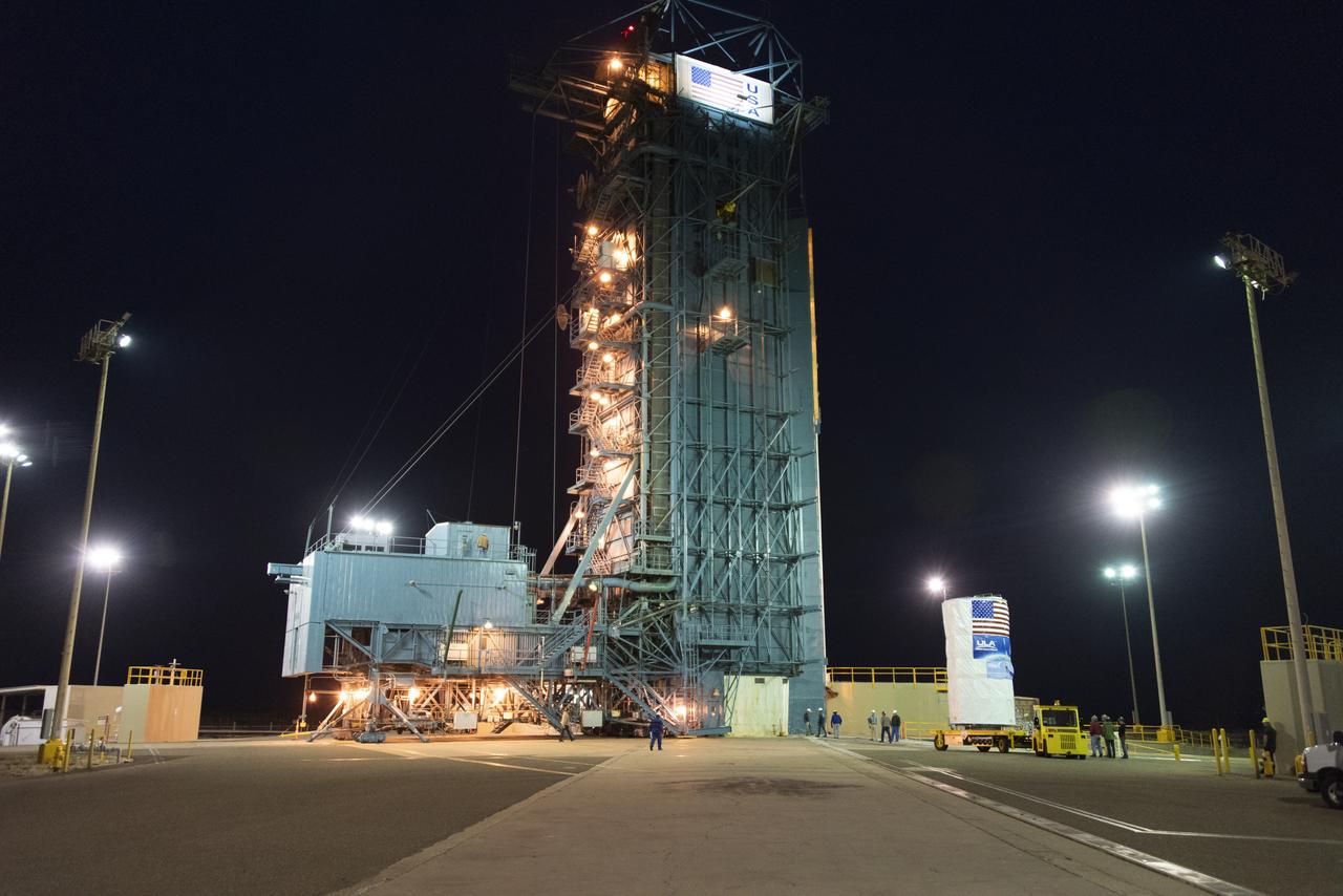 NASA's Ice, Cloud and land Elevation Satellite-2 (ICESat-2), at right, encased in its protective covering, arrives at the mobile service tower at Space Launch Complex 2 at Vandenberg Air Force Base in California, on Aug. 26, 2018. The satellite will be hoisted up by crane and attached to the United Launch Alliance Delta II rocket. Launch is scheduled for Sept. 15, 2018. ICESat-2 will measure the height of a changing Earth, one laser pulse at a time, 10,000 laser pulses a second. The satellite will carry the Advanced Topographic Laser Altimeter System (ATLAS). ICESat-2 will help scientists investigate why, and how much our planet's frozen and icy areas, called the cryosphere, are changing in a warming climate.