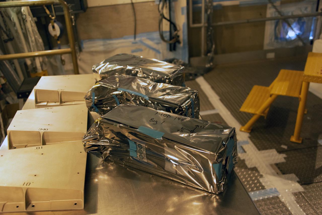 At Space Launch Complex 2 at Vandenberg Air Force Base in California, three poly picosatellite orbital deployers, or P-POD containers, with tiny satellites, called CubeSats inside, are being prepared for installation on the direct mate adapter of the United Launch Alliance Delta II rocket, on Aug. 31, 2018. NASA's Ice, Cloud and land Elevation Satellite-2 (ICESat-2) is ready for launch aboard the final Delta II rocket. Launch is scheduled for Sept. 15, 2018. ICESat-2 will measure the height of a changing Earth, one laser pulse at a time, 10,000 laser pulses a second. The satellite will carry the Advanced Topographic Laser Altimeter System (ATLAS). ICESat-2 will help scientists investigate why, and how much our planet's frozen and icy areas, called the cryosphere, are changing in a warming climate.